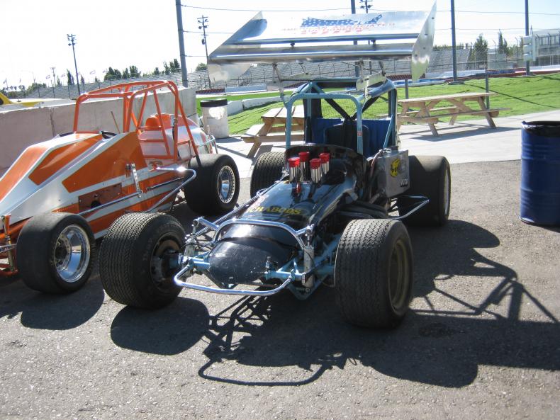 ORANGE AND WHITE CAR ON LEFT IS A SILVER CROWN SPRINT.JPG